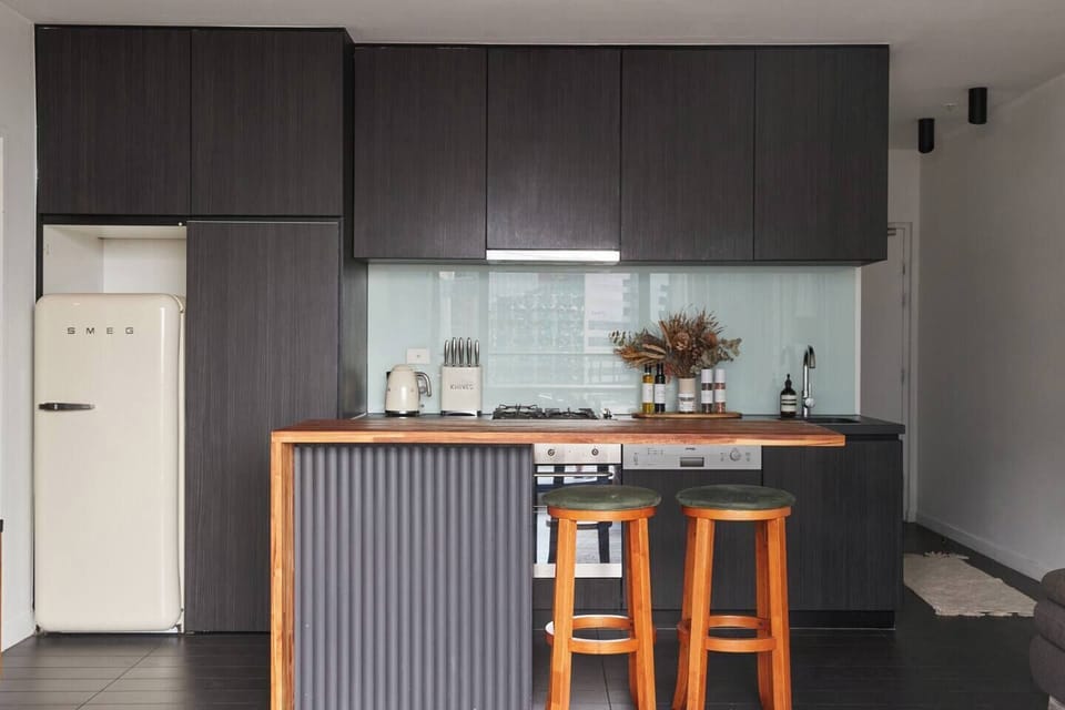 Dine casually in the kitchen with two bar stools neatly stowed away under the kitchen island. 