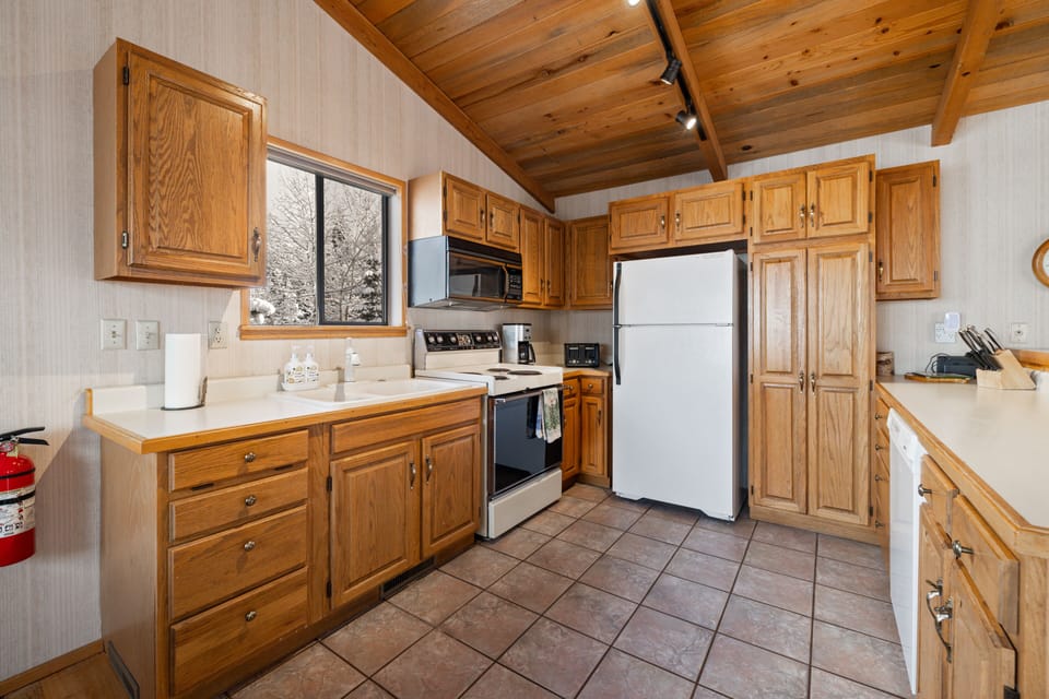 Kitchen is equipped with a generous pantry for food storage