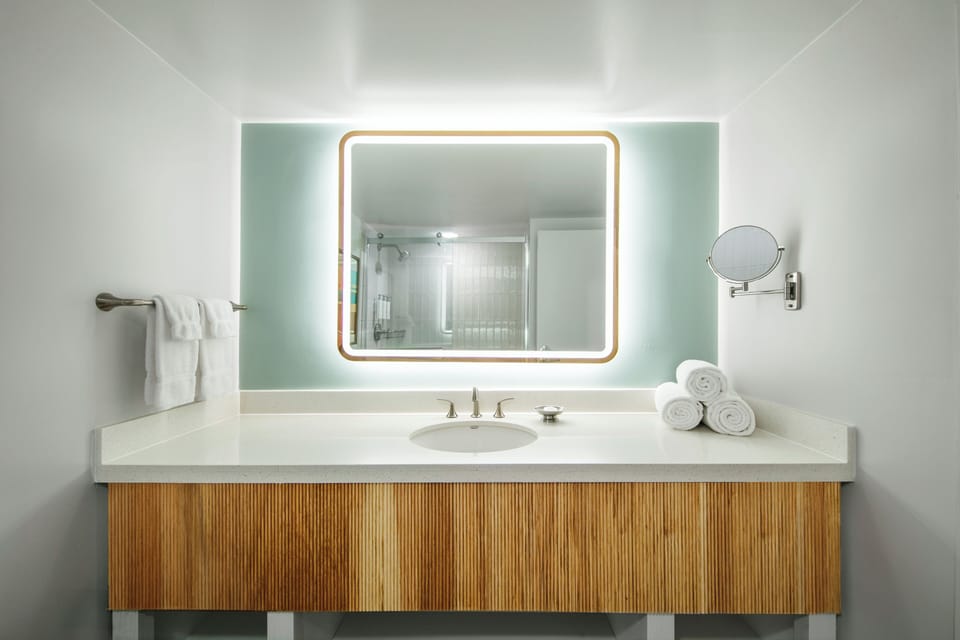 Refresh at a spa-like vanity with glowing mirror lighting.
