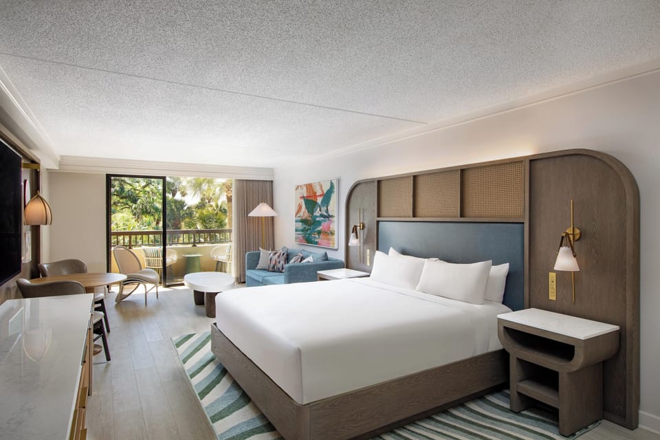 Stretch out in a bright studio with balcony and lounge seating.