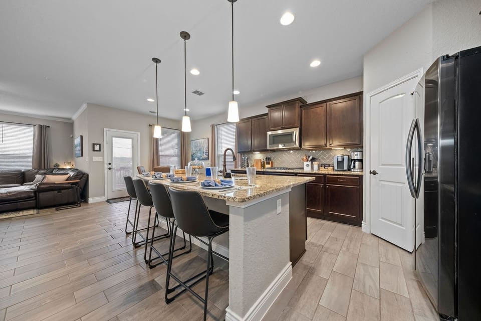 Kitchen has seating for 8, with 4 at the table and 4 at the bar.