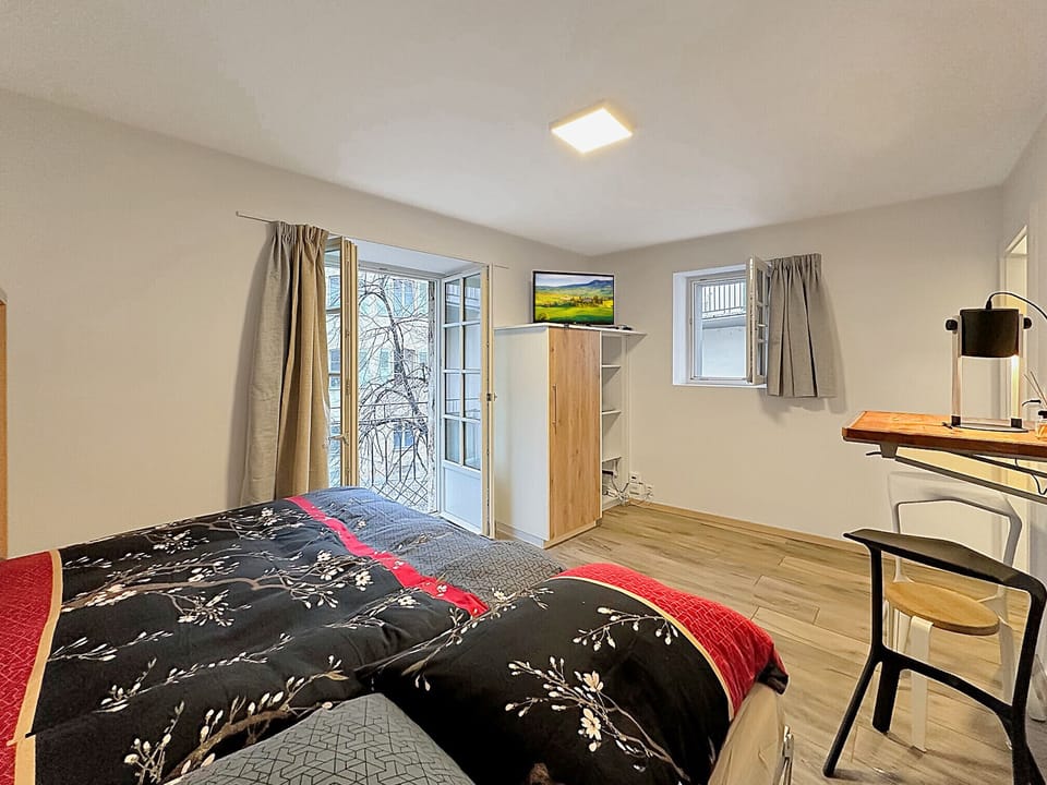 Comfortable double bed overlooking the studio.