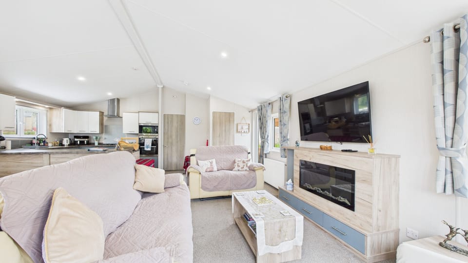 Cosy open-plan living area with kitchen and dining.