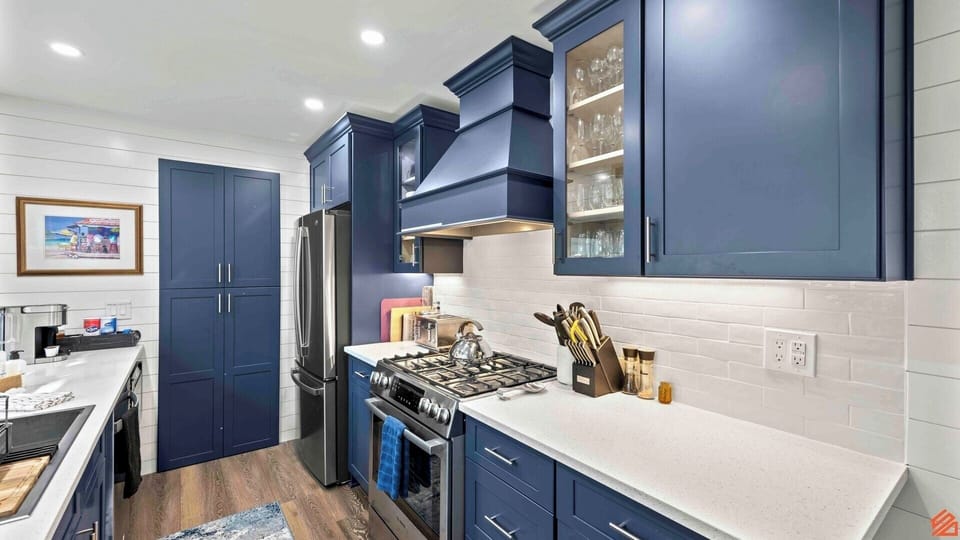 A modern and spacious kitchen equipped with state-of-the-art appliances and ample counter space, creating an inviting and efficient culinary environment for preparing meals and entertaining guests.