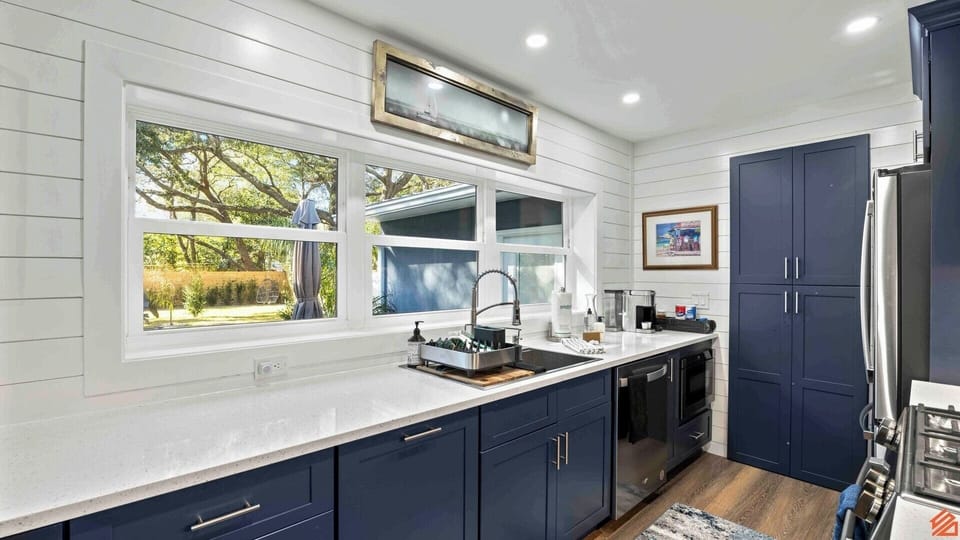 A stylish and functional kitchen featuring sleek countertops, high-end appliances, and abundant natural light, ideal for both cooking gourmet meals and socializing with friends and family.