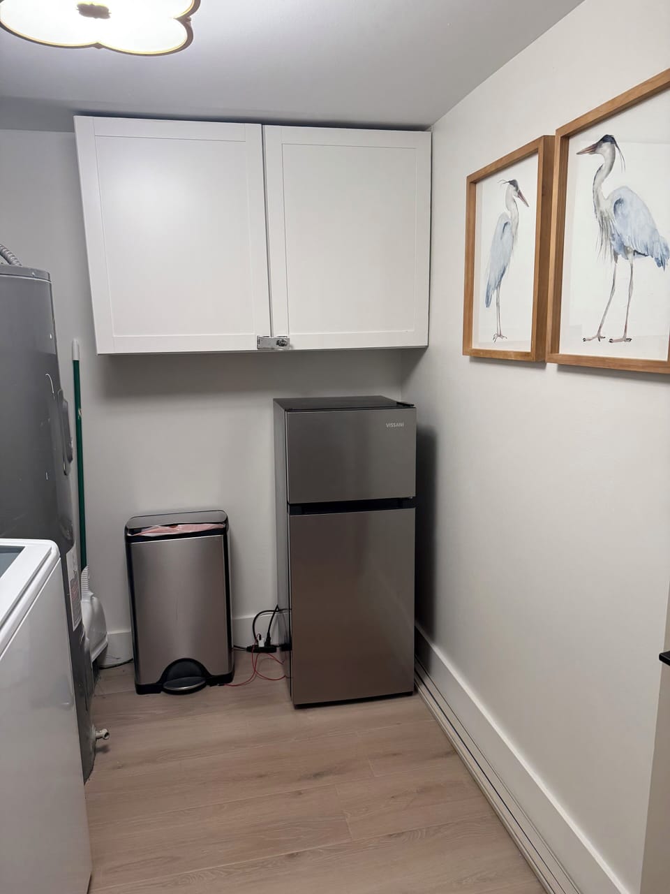 Laundry room offers a little extra fridge space and some extra towels 