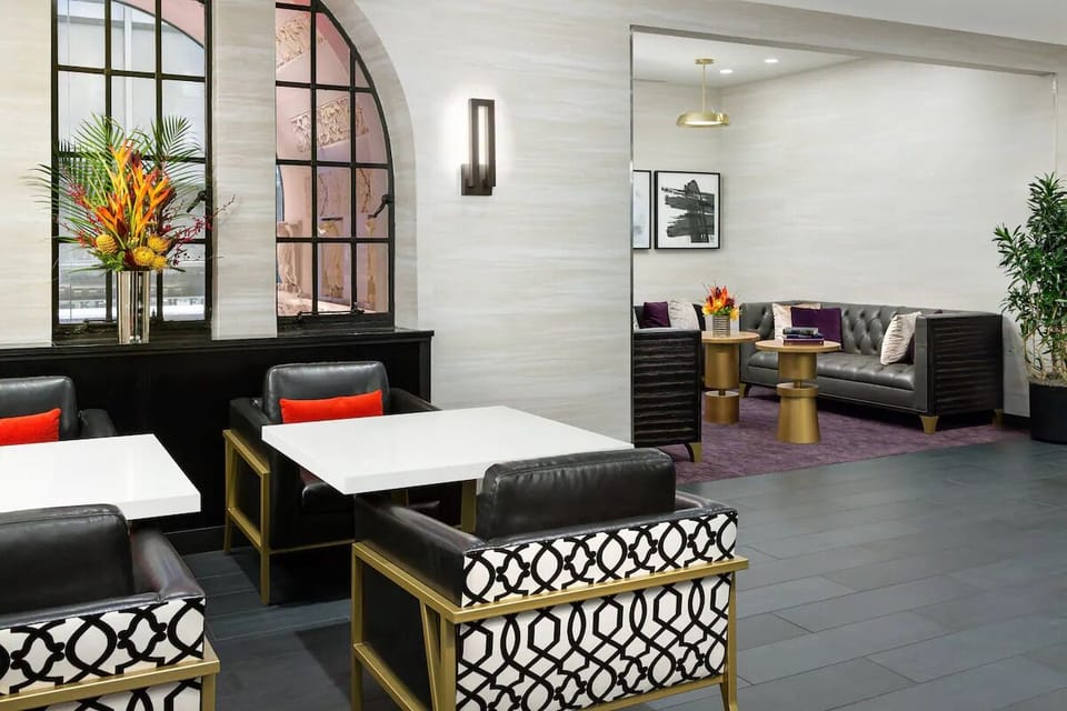 Unwind in stylish lounge seating with light-filled city charm.