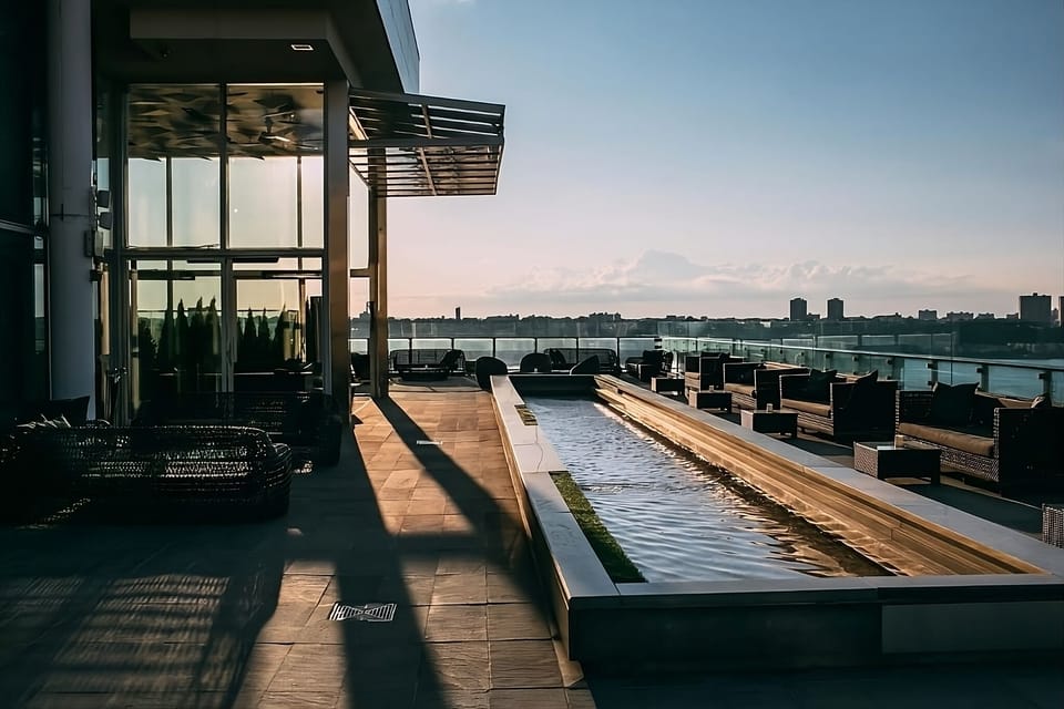 Unwind at sunset as the rooftop glows over the city.