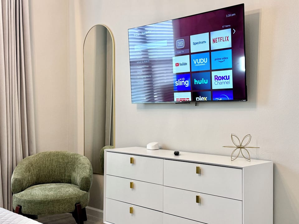 Smart TV, mirror and armchair, all complete for your comfort.