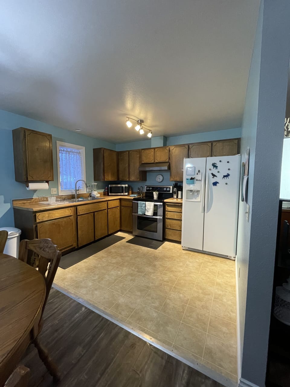 Fully stocked kitchen, double oven, microwave, and fridge with ice maker