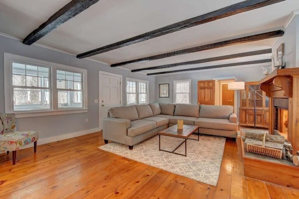 This living room has an oversized sectional with a large fireplace and smart TV.