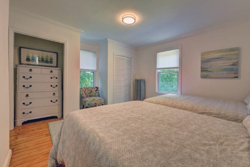 Bedroom 3: Two comfortable full-size beds with a closet and dresser.