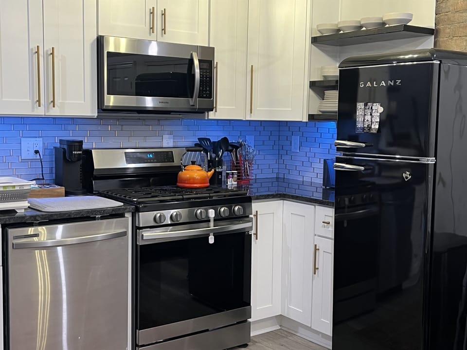 Gas range, tea kettle, and fancy blue lights.