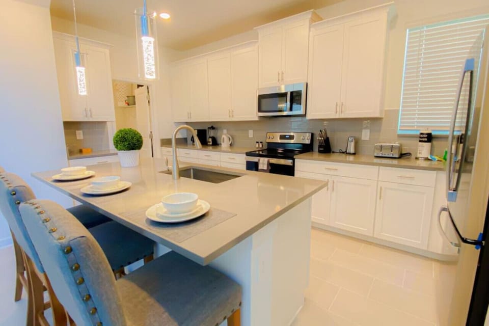 Prepare delicious meals in our fully equipped kitchen, featuring modern appliances and ample counter space.