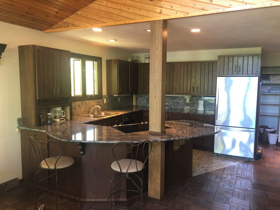 Kitchen with wrap around granite countertop.