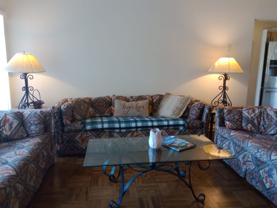 Living room with 3 couches and TV