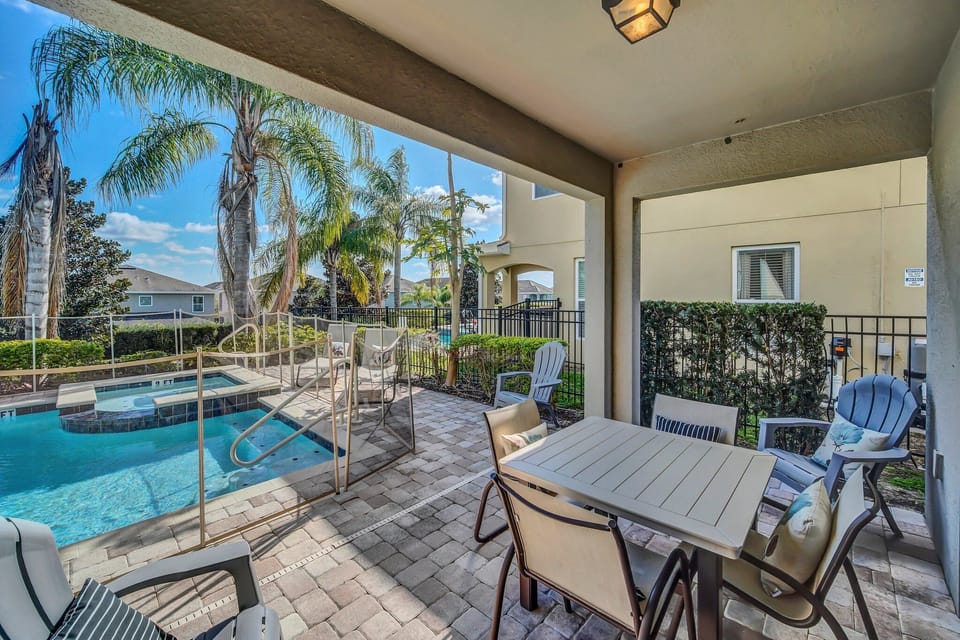 Outdoor dining under a covered lanai—ideal for poolside family meals or shaded relaxation.