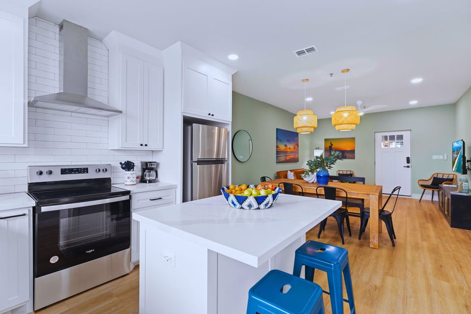 The sleek chef’s kitchen features a spacious waterfall island and elegant designer finishes. Outfitted with high-end appliances and fully stocked essentials, it’s designed for everything from effortless snacks to gourmet creations.