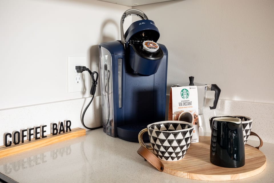 Coffee station w/ single-serve maker & mugs ready for your morning brew