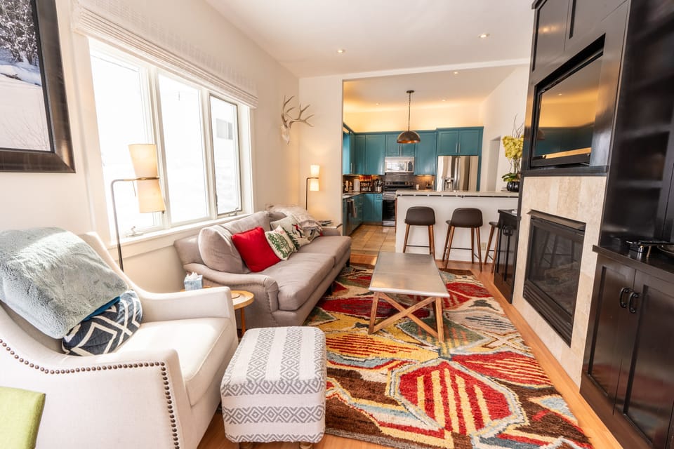 Remodeled cozy living room with fireplace and tv