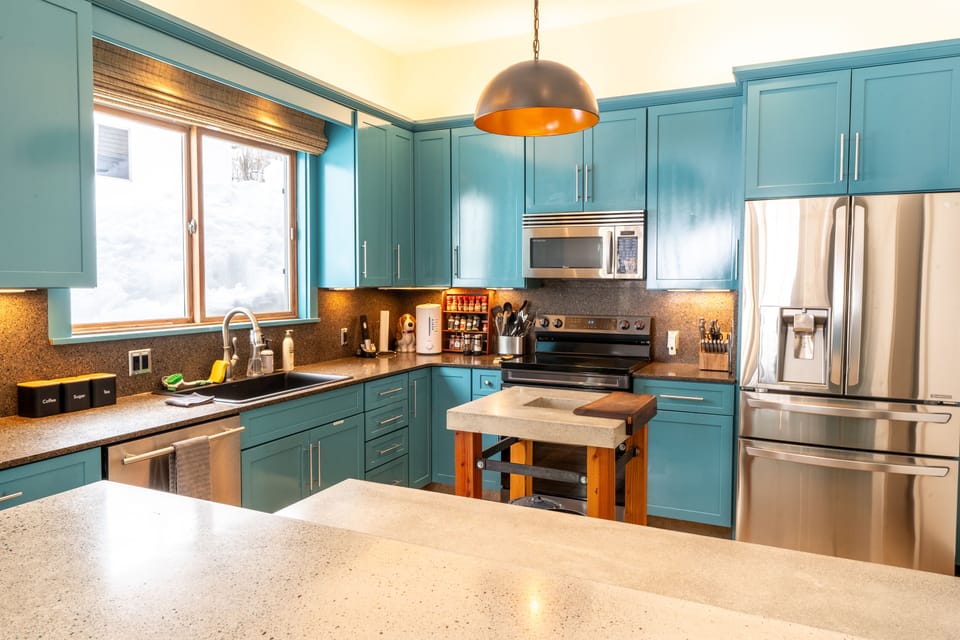Gourmet kitchen with stainless appliances and full cookware