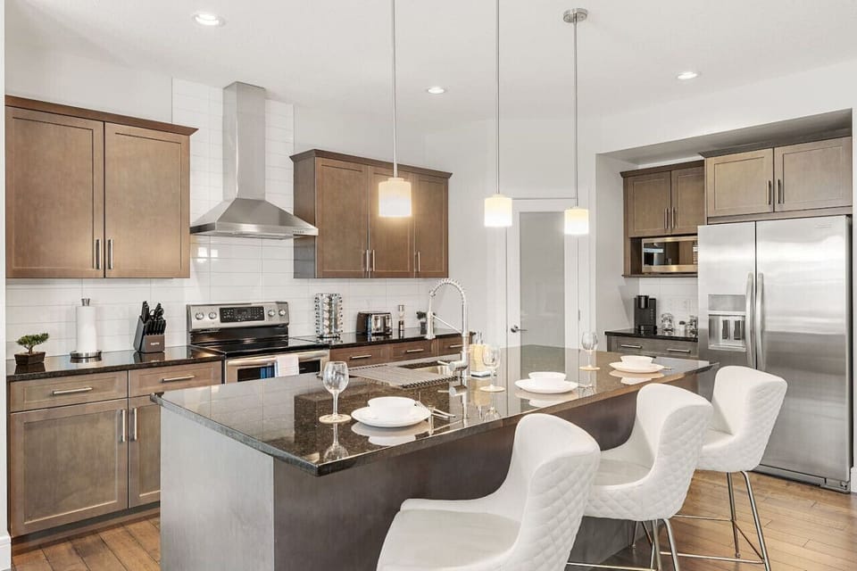 Fully-equipped kitchen, boasting a spice rack, ice maker, modern appliances, and a coffee machine for your morning brew.