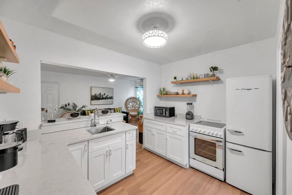 Clean white kitchen w/ ample counter space & modern appliances for easy meals