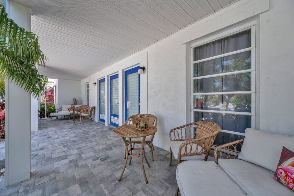 Covered outdoor dining area w/ wicker seating, great for relaxed meals in the fresh air.