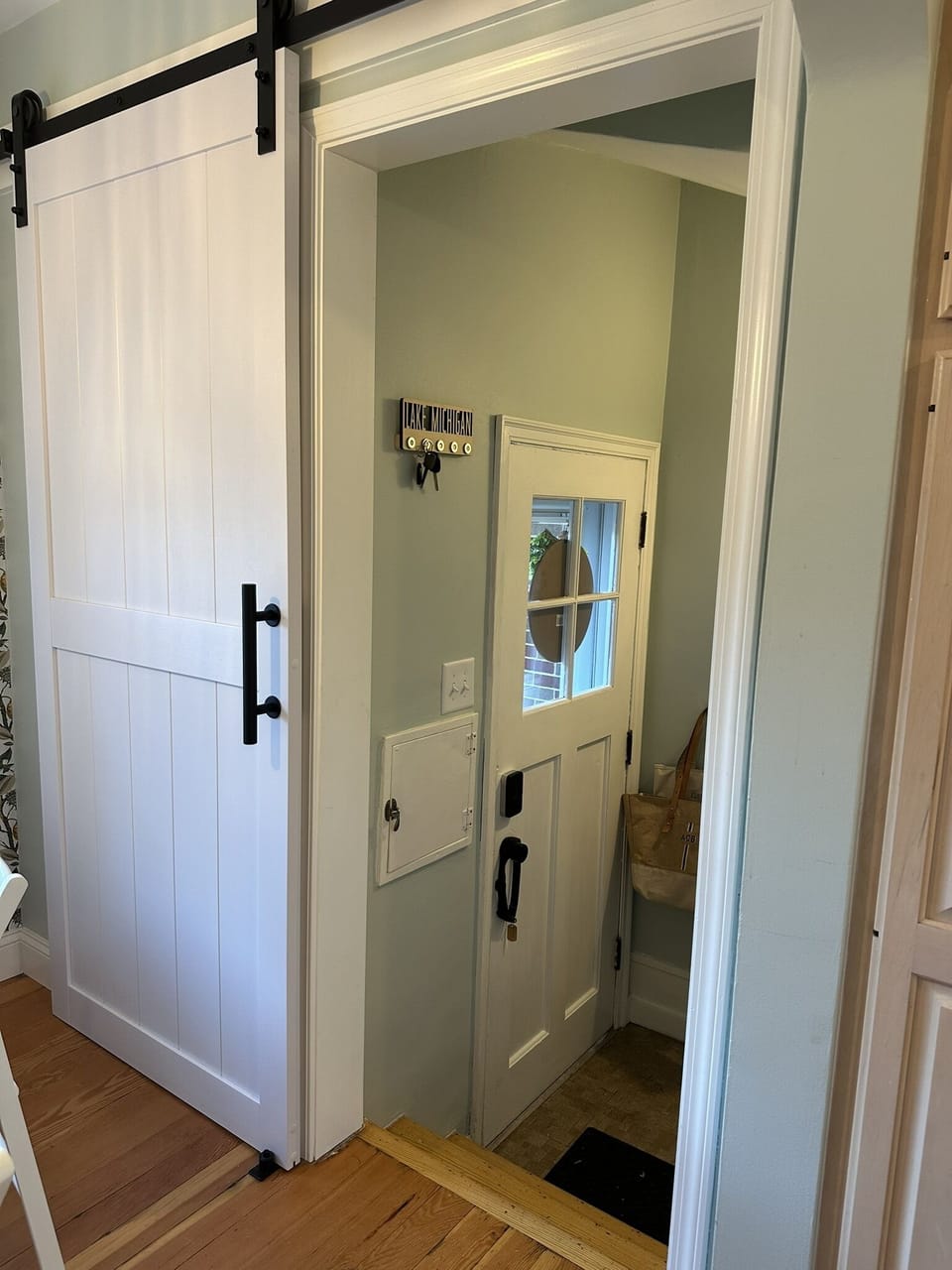 Barn door open to back door and entrance to basement.