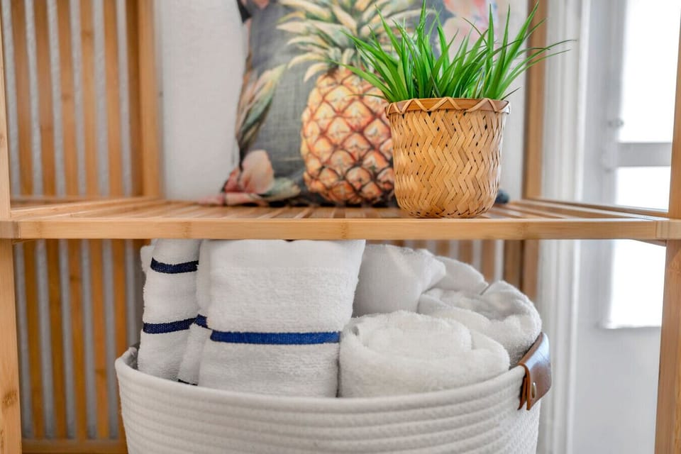 Neatly stacked towels & simple decor add a clean, spa-like feel.