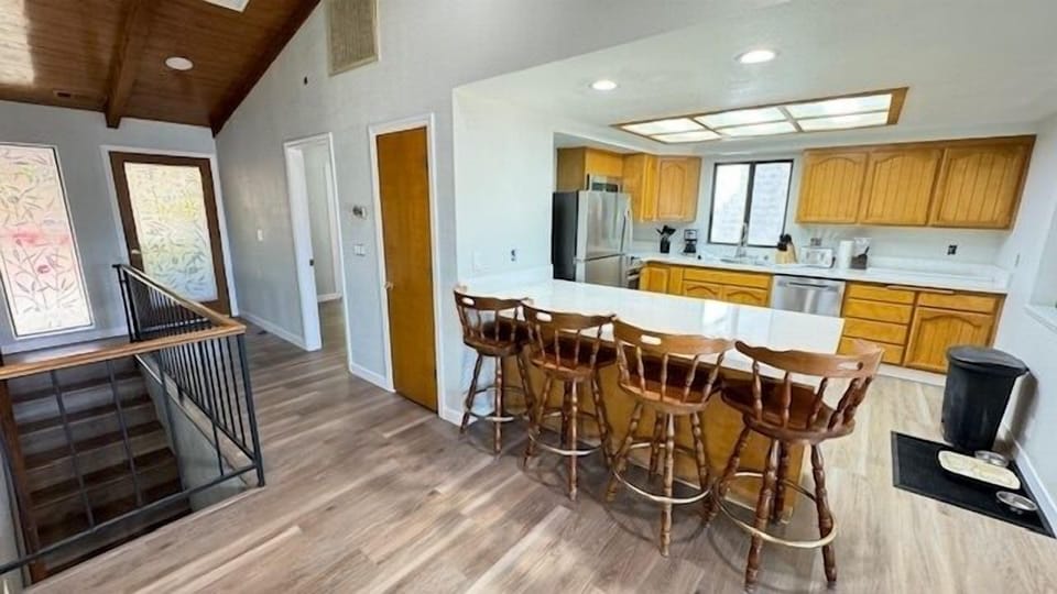 Well stocked kitchen and comfy bar seating.