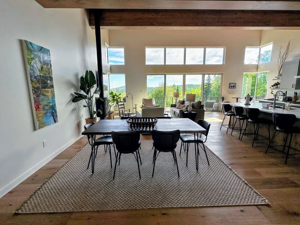 Lovely kitchen, dining, and living space on the main level with large windows and mountain views.