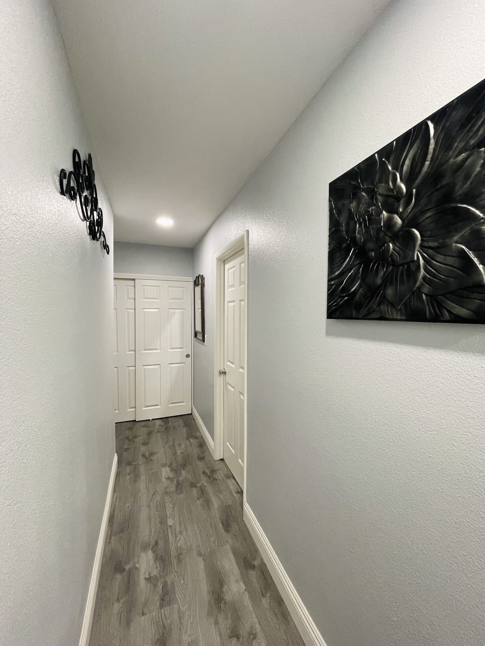 Outside bedroom 3 hallway leading to bedroom 4 & 5 and sliding closet at the end