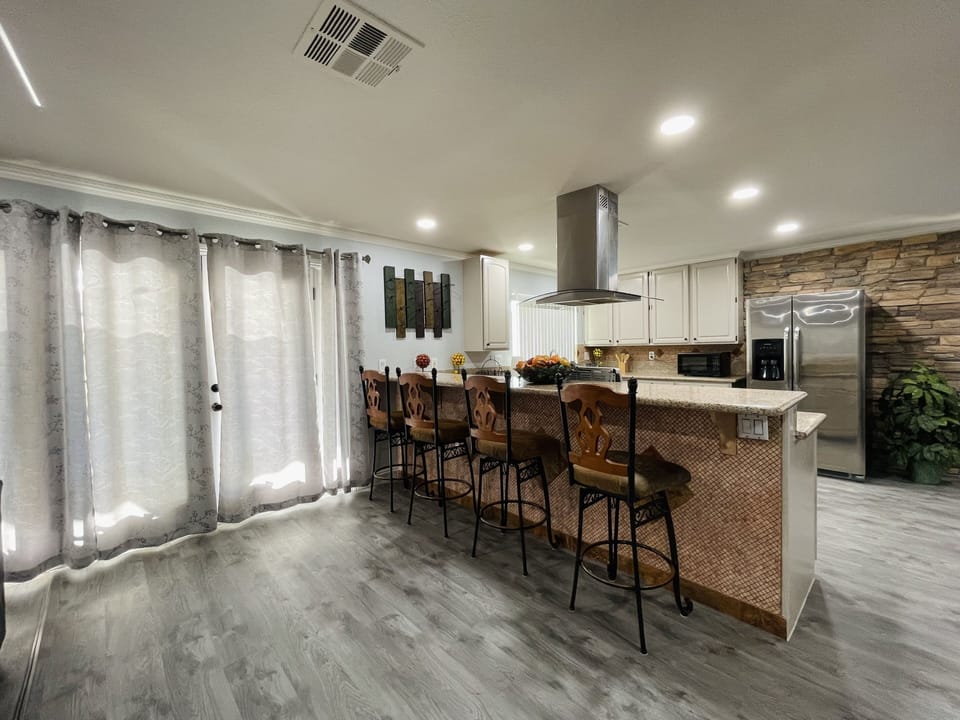 Doors that lead to the backyard and first view of kitchen + seating.