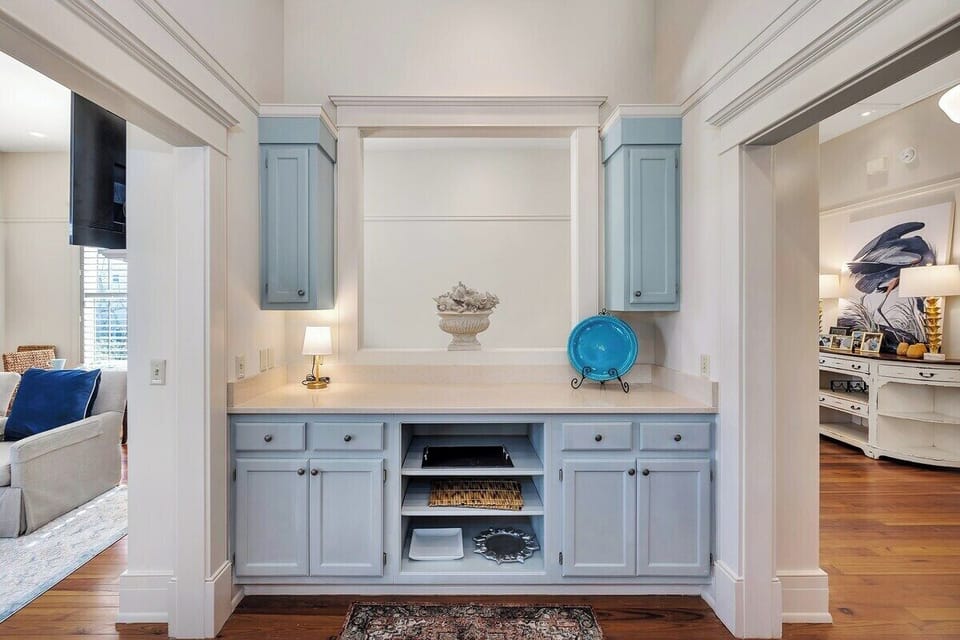 Light blue built-in cabinetry with white countertop and shelving