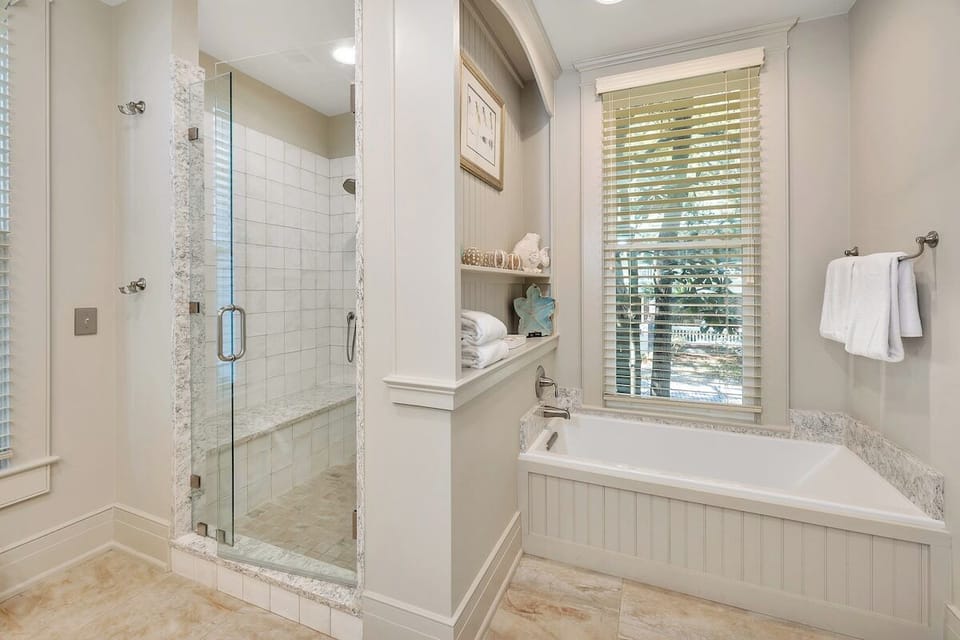 Batroom with glass-door walk-in shower and bathtub