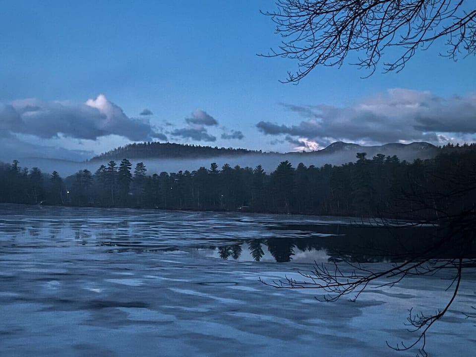Outside, winter evenings soften the landscape into shades of blue, inviting you to warm up indoors while the shoreline grows still.