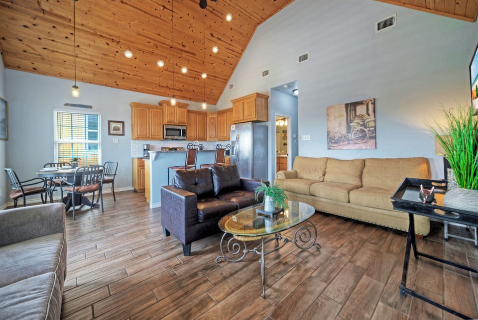 Cozy living room with vaulted wood ceilings, relaxed seating, and a warm coastal feel.