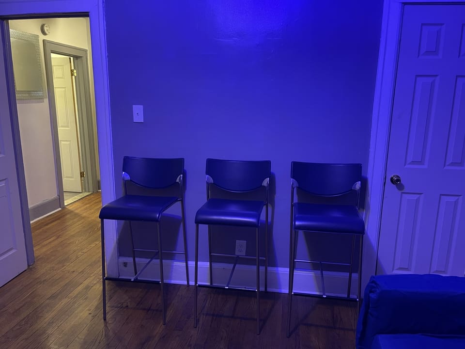 Den/bar has 55 inch smart tv, couch, 3 bar stools and bar for drink set up. 