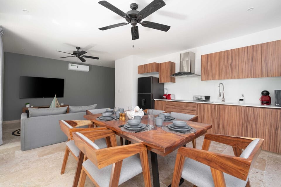Embrace the natural elegance of our wood-themed dining area and kitchen, seamlessly connected across the inviting living room