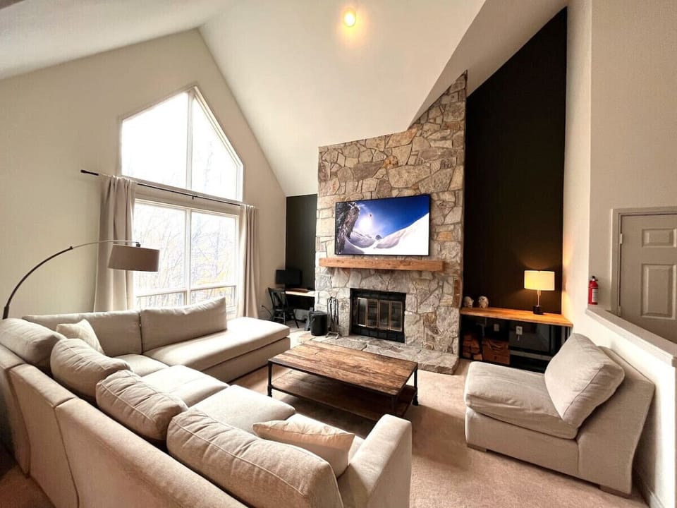 Open concept living area with huge couch and 65` Smart TV