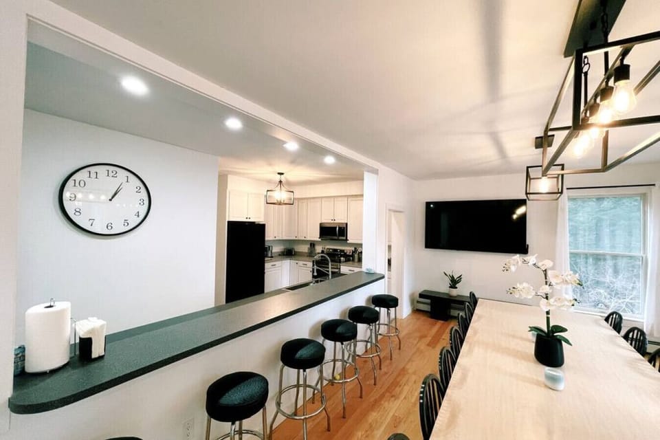 Kitchen and dining area overlooking the lake. Dining table seats 14. Island seats 6. 65` Smart TV