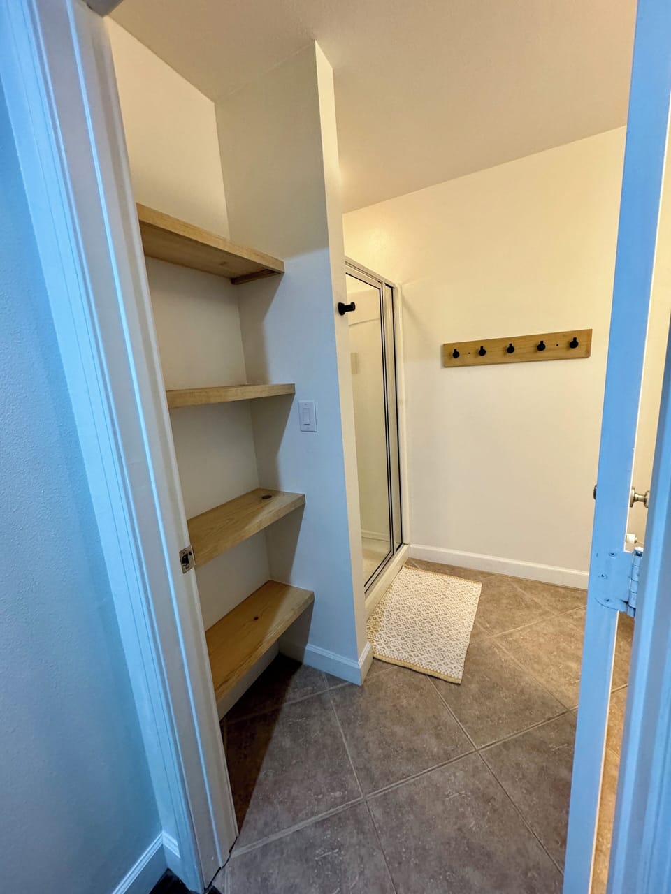 Bathroom shelves give plenty of space for your things and towels.