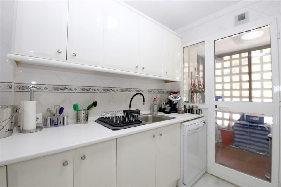 Another picture of the kitchen with laundry room to the rear