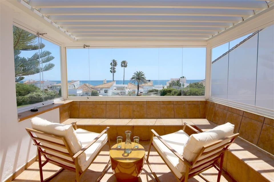 Seating area on the terrace with stunning views to the pool and sea