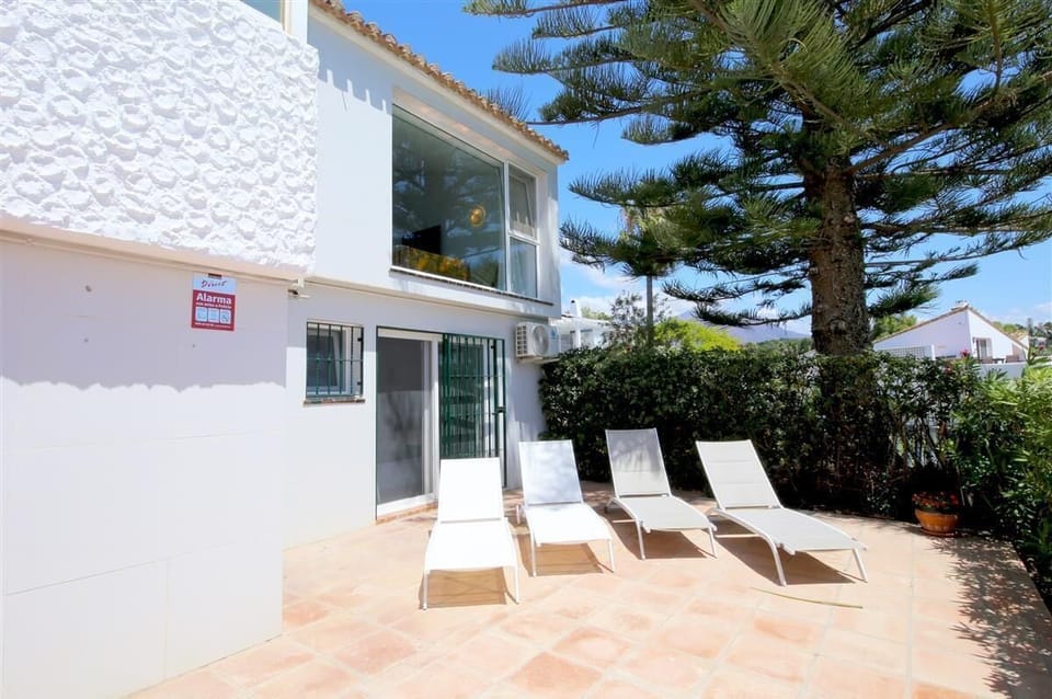View of the property from the communal gardens and pool area