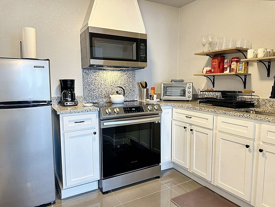 The kitchen is a chef’s dream, combining modern appliances with sleek, elegant design.