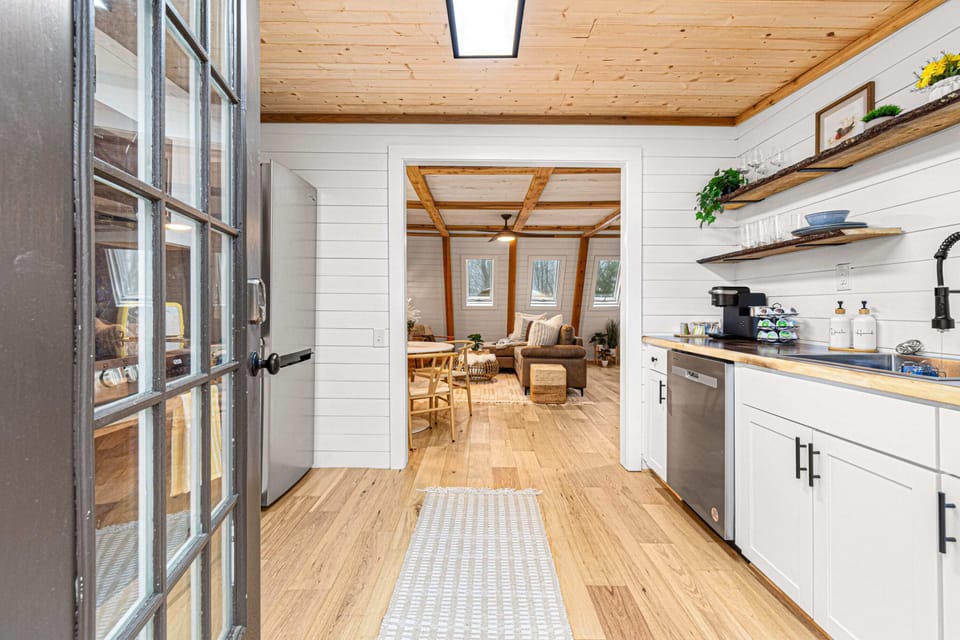 Enter into our fully equipped kitchen with views into our living and dining space.