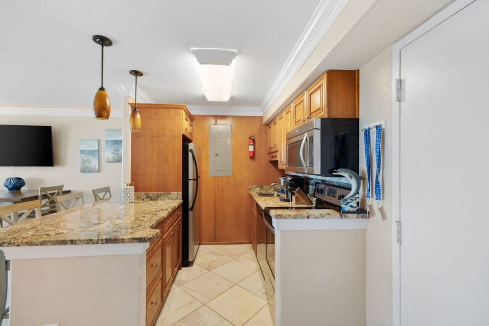 Fully stocked kitchen with granite counters and stainless appliances, everything you need for easy meals and beach snacks.