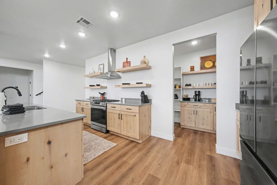 Amazing kitchen featuring a full sized oven, french door fridge and dishwasher.